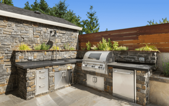 custom outdoor kitchen with grill, sink, dishwasher and more