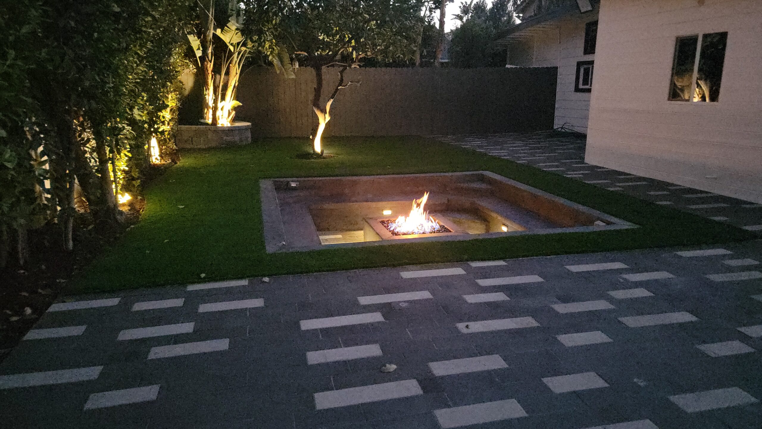 Backyard renovation including a fire pit, paver installation and patio in the los angeles area.