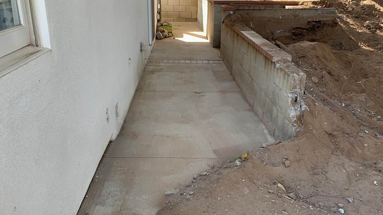 Removing existing concrete before new pavers