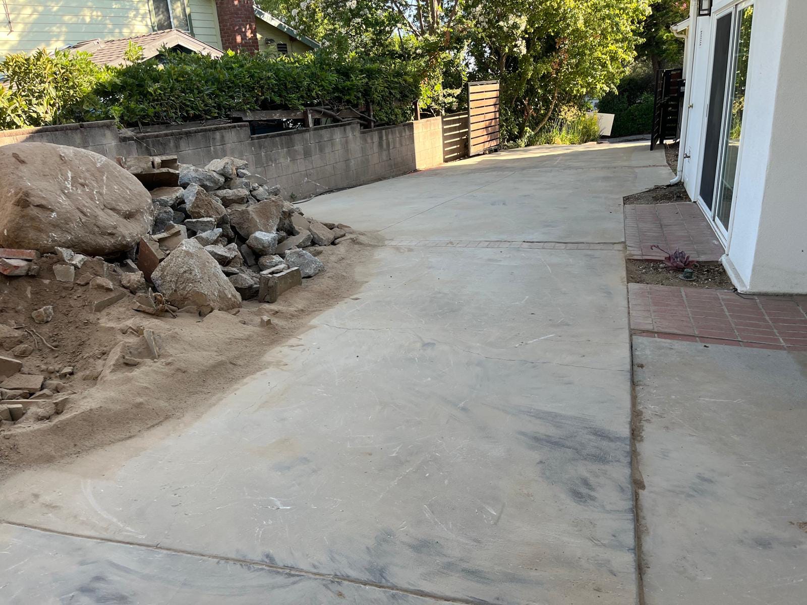 Old cracked concrete driveway before paver installation