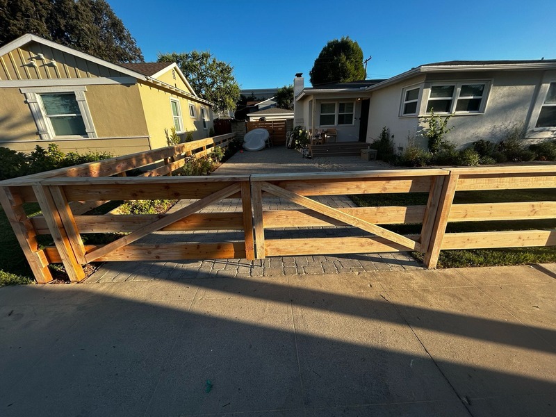 Custom wood driveway gate and fence installation for front yard entrance in Orange California