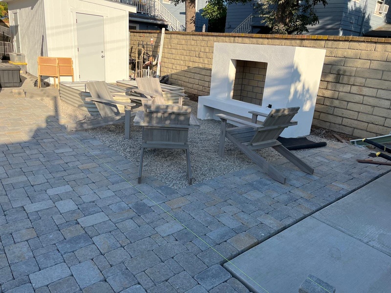 Finished custom outdoor fireplace with paver patio and seating area in Orange CA