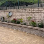 Small backyard paver patio and retaining wall remodel with custom hardscape and landscape construction.