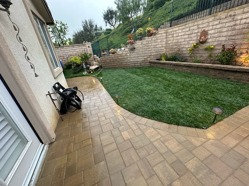 Small backyard paver patio and retaining wall remodel with custom hardscape and landscape construction
