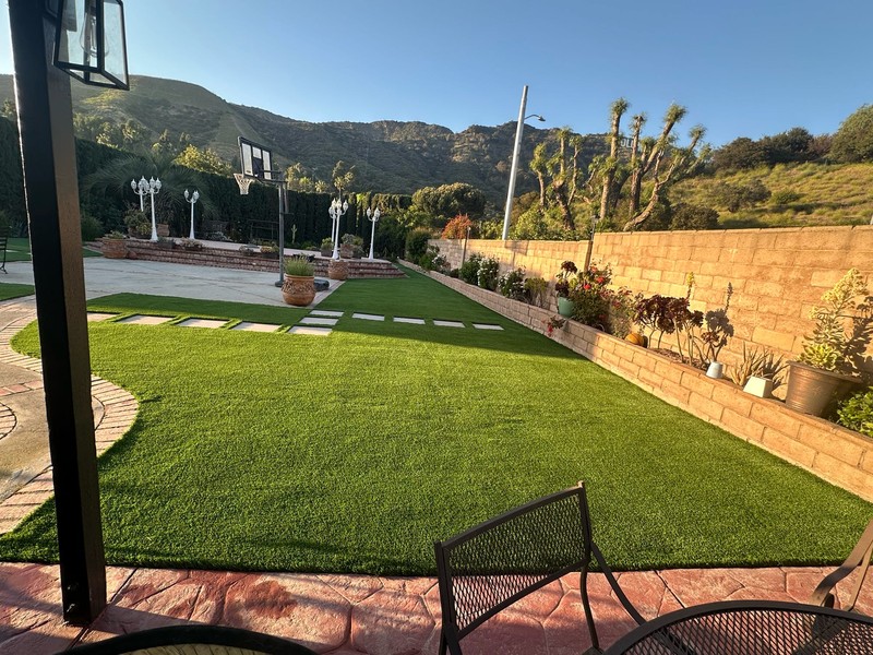 Luxury low-maintenance backyard with custom stepping stone pathway.