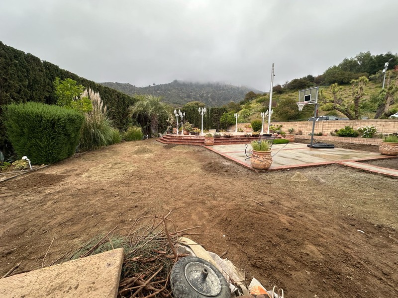 Initial grading and landscape renovation before artificial turf installation.