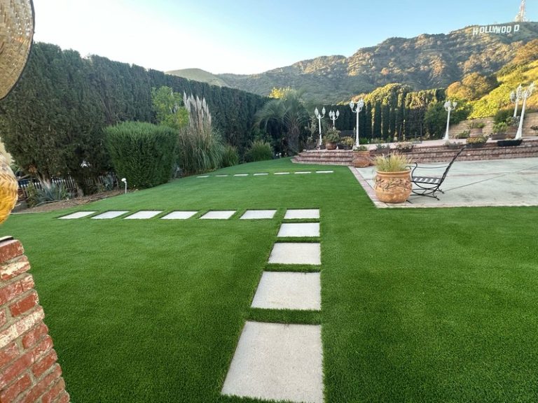 Finished backyard remodeling project featuring premium artificial grass.