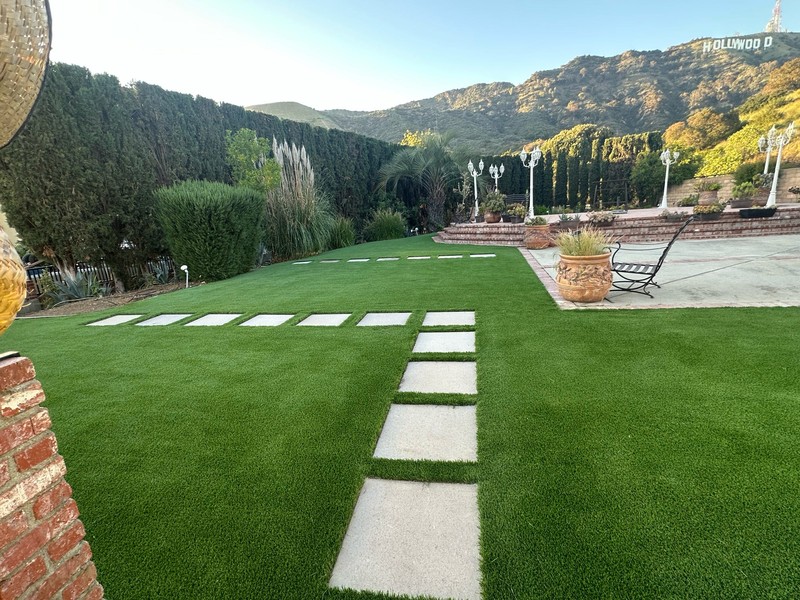 Finished backyard remodeling project featuring premium artificial grass.